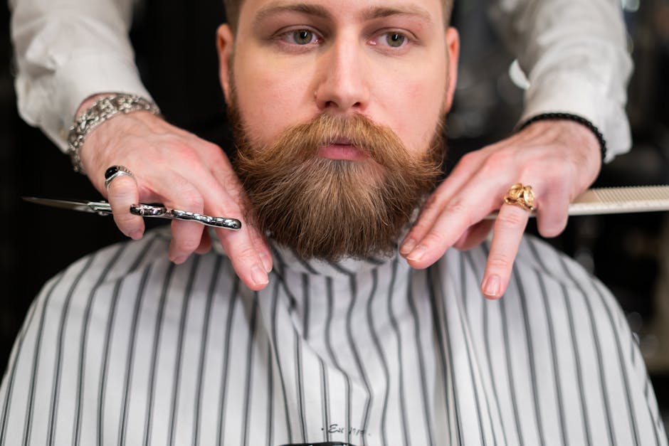 Barber trimming a beard with precision